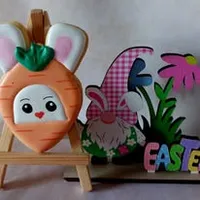 Cute carrot-shaped bunny iced cookie with green top and smiling face on a wooden stand