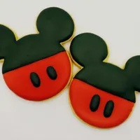 9cm Mickey Mouse head shaped iced cookies with iconic black ears and red face with black button details