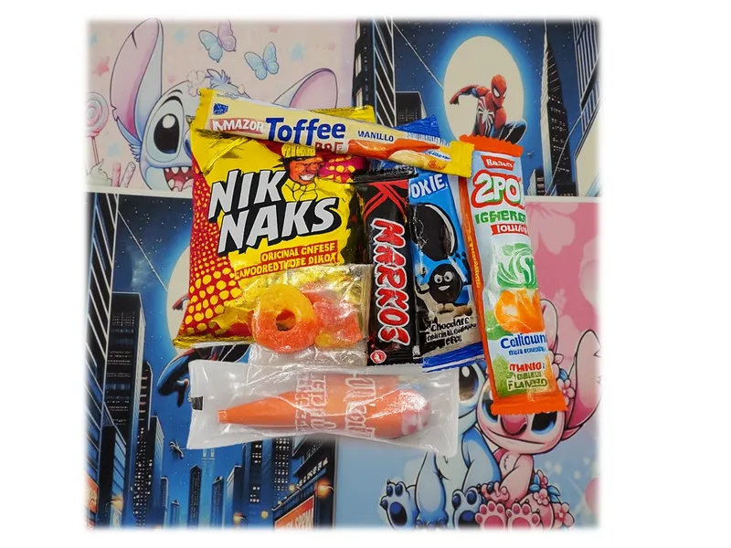 Fun party pack featuring assorted treats including Nik Naks, toffees, cookies, and sweets on a colorful character-themed background